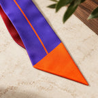 Dettaglio della punta diagonale arancio e del profilo sottile del Twilly viola.